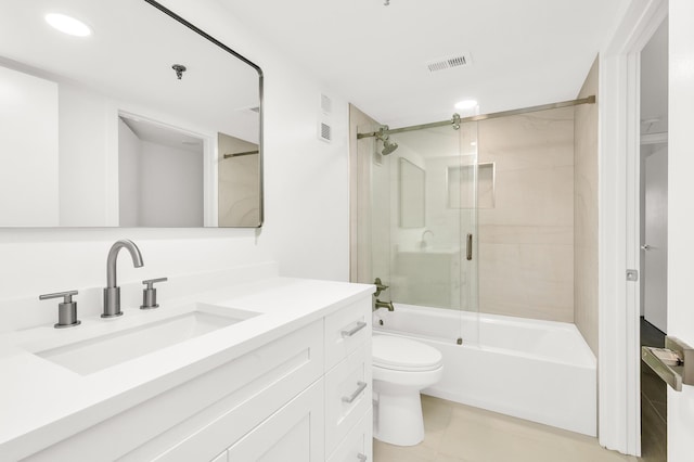 full bathroom with tile patterned flooring, vanity, enclosed tub / shower combo, and toilet