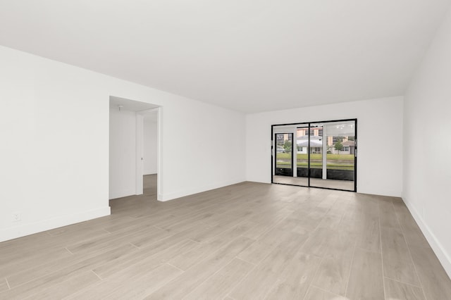 unfurnished room with light wood-type flooring