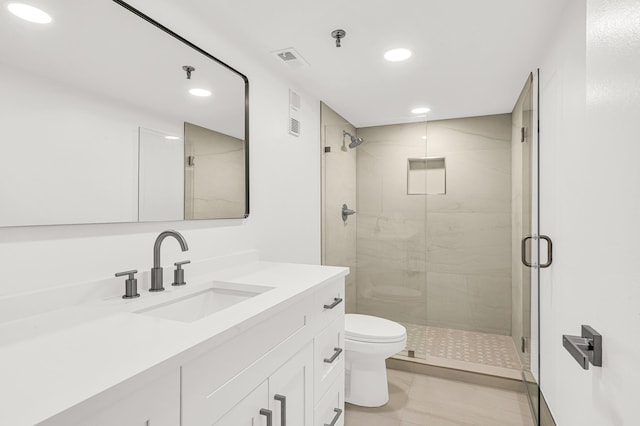 bathroom with tile patterned flooring, vanity, toilet, and an enclosed shower