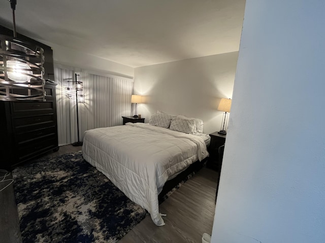 bedroom with dark wood-type flooring