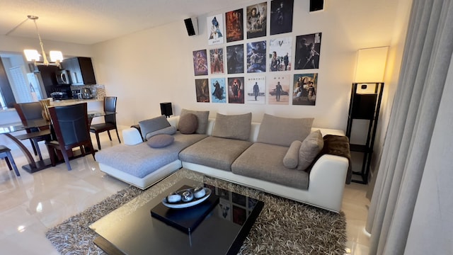 living room featuring tile patterned floors and an inviting chandelier