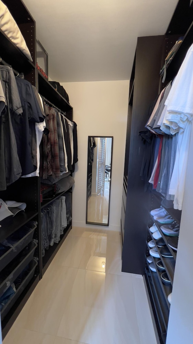 walk in closet featuring light tile patterned flooring