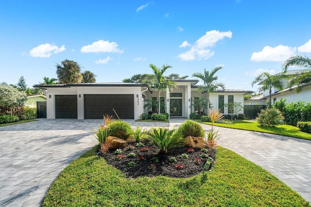 single story home with a front yard and a garage