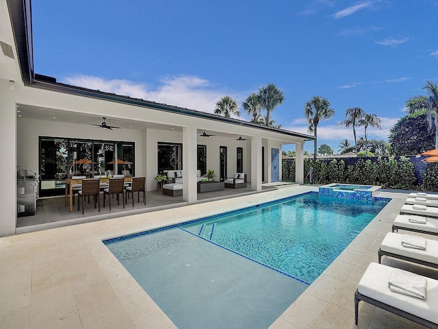 view of pool featuring an in ground hot tub, ceiling fan, a patio, and an outdoor hangout area