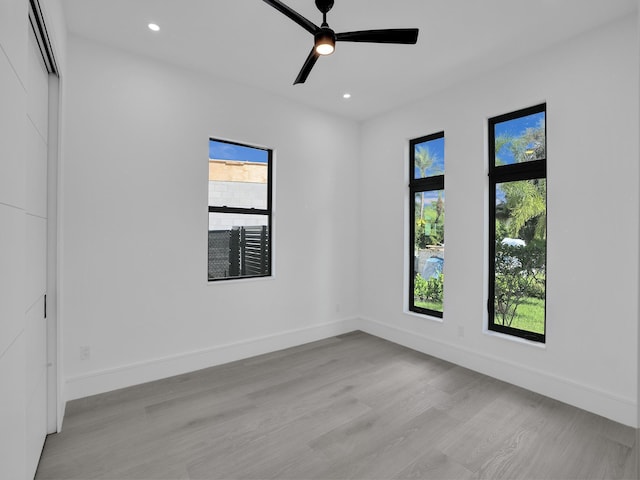 spare room featuring ceiling fan and light hardwood / wood-style floors