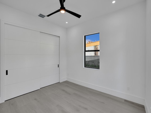 empty room featuring light hardwood / wood-style flooring and ceiling fan