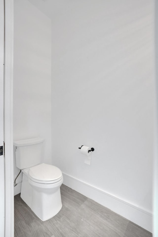 bathroom featuring wood-type flooring and toilet