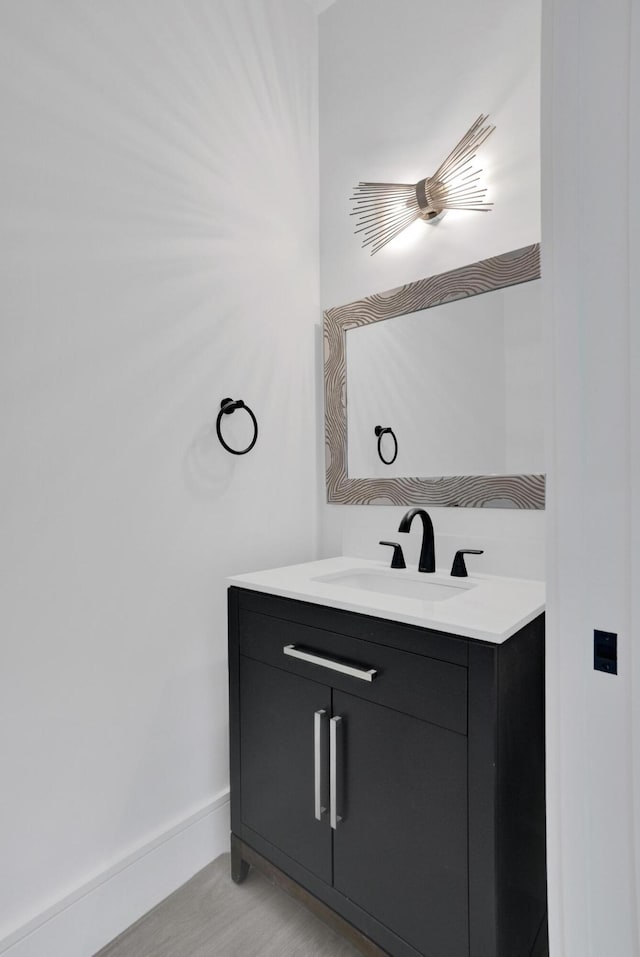 bathroom with hardwood / wood-style floors and vanity