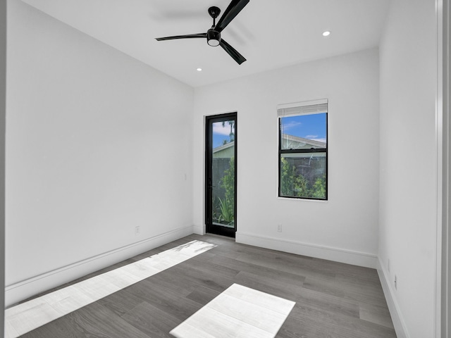 empty room with light wood-type flooring and ceiling fan