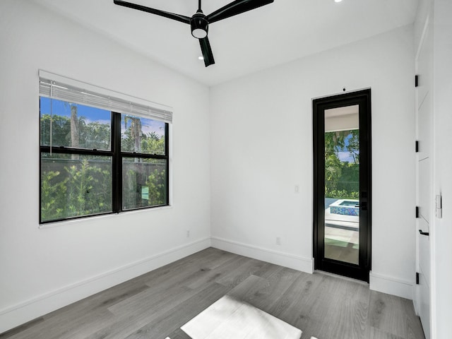 unfurnished room with ceiling fan and light hardwood / wood-style flooring