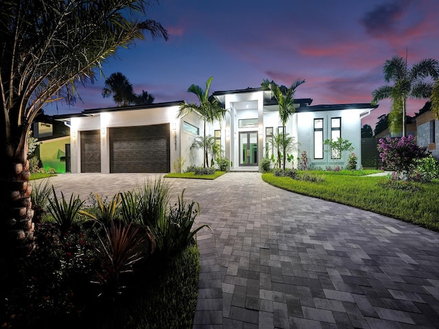 contemporary home featuring a garage and french doors