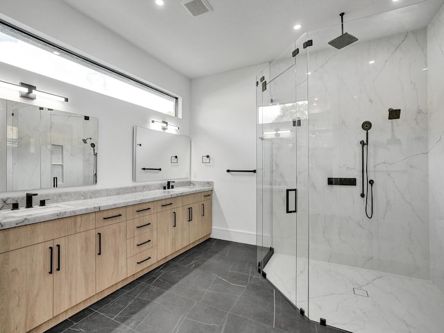 bathroom featuring vanity and a shower with shower door