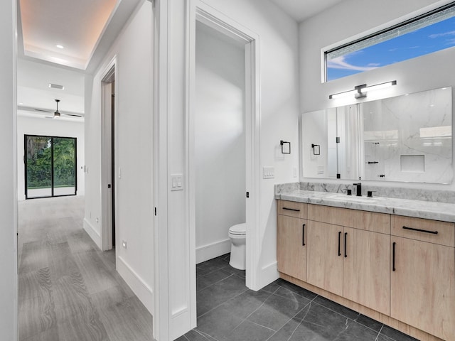 bathroom featuring tile patterned floors, vanity, and toilet