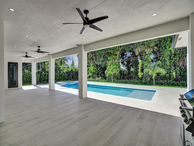 view of pool with an in ground hot tub and a patio area