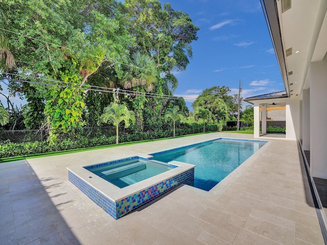 view of swimming pool featuring an in ground hot tub, ceiling fan, and a patio area