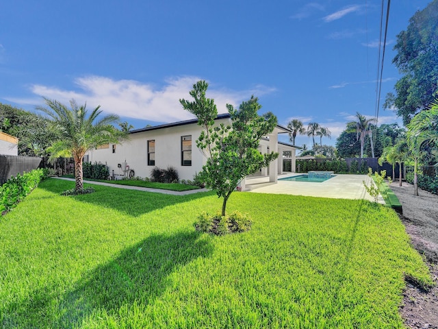 view of yard featuring a fenced in pool and a patio