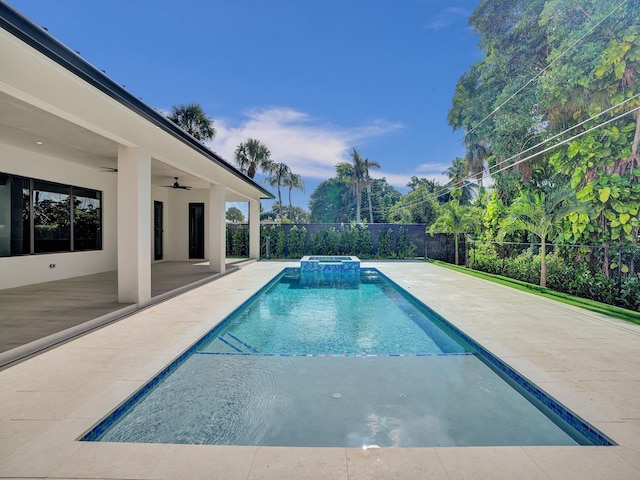 view of pool featuring an in ground hot tub, ceiling fan, and a patio area