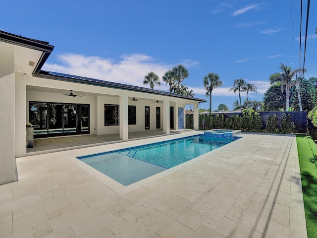 view of pool featuring an in ground hot tub, ceiling fan, and a patio area