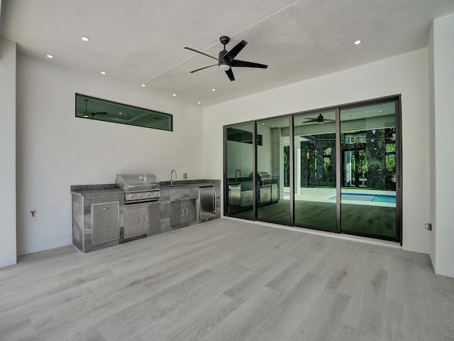 view of patio / terrace featuring area for grilling, a grill, sink, and ceiling fan