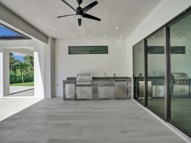 view of patio with sink, area for grilling, grilling area, and ceiling fan