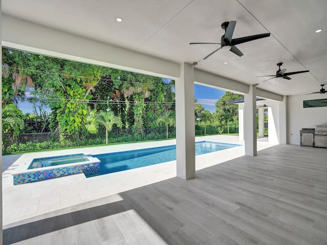 view of pool with an in ground hot tub