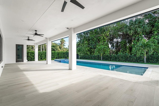 view of swimming pool with an in ground hot tub