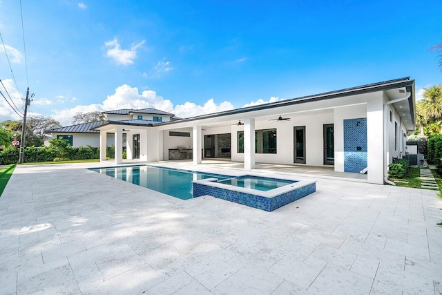 view of pool with ceiling fan, an in ground hot tub, a patio, and central AC