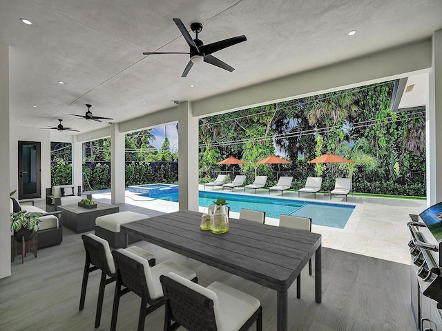 view of pool with a patio area and an in ground hot tub