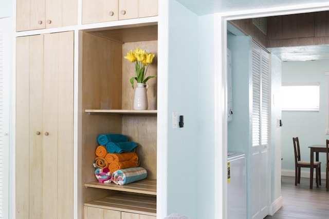 clothes washing area featuring stacked washer / dryer