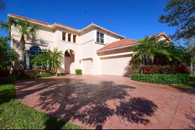 mediterranean / spanish home featuring a garage