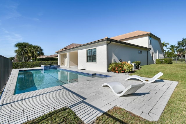 view of pool with a patio area and a yard