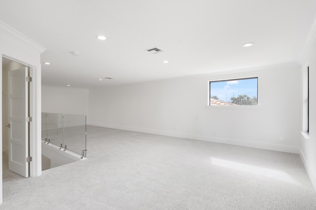 spare room with light carpet and ornamental molding