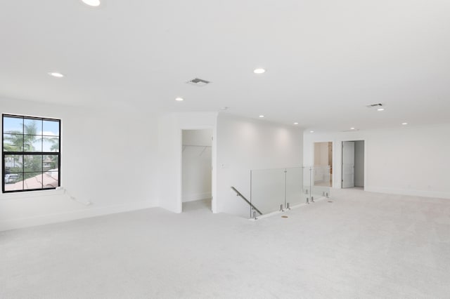 unfurnished room featuring light colored carpet and ornamental molding