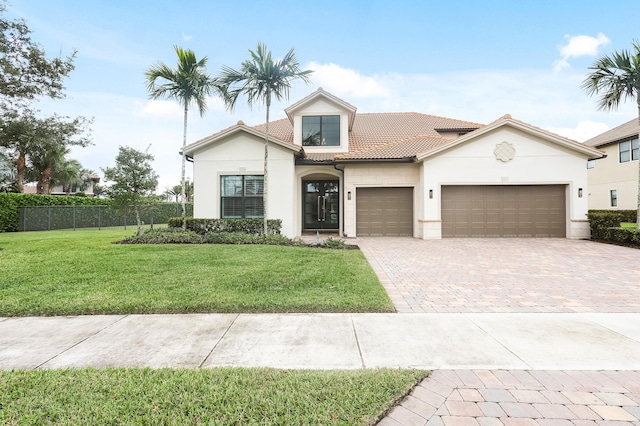 view of front facade featuring a front lawn and a garage