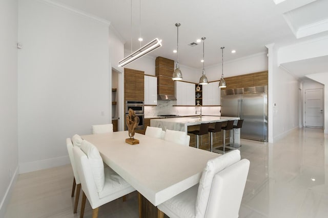 dining space featuring crown molding and sink