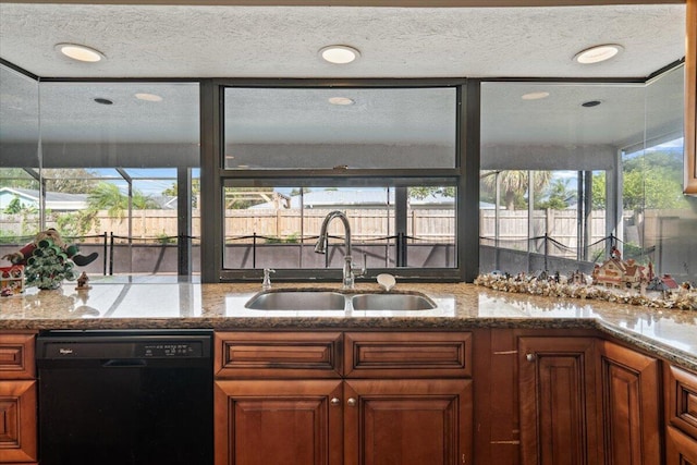 kitchen with light stone countertops, sink, a textured ceiling, and black dishwasher