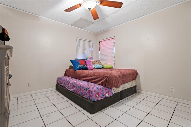 bedroom featuring light tile patterned flooring, a textured ceiling, and baseboards