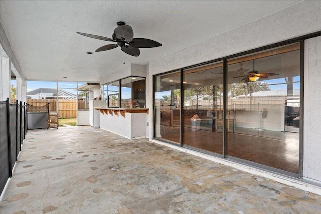 view of patio / terrace with a ceiling fan and fence