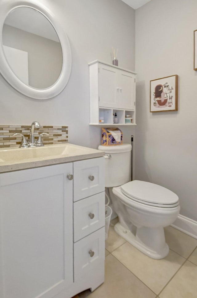 bathroom featuring tasteful backsplash, tile patterned flooring, vanity, and toilet