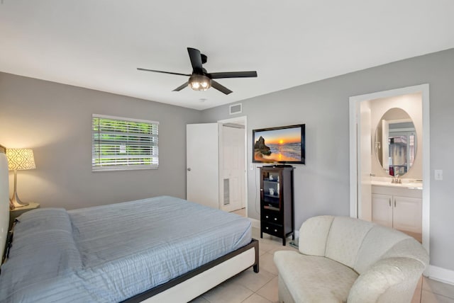 bedroom featuring sink, ensuite bathroom, ceiling fan, and light tile patterned flooring