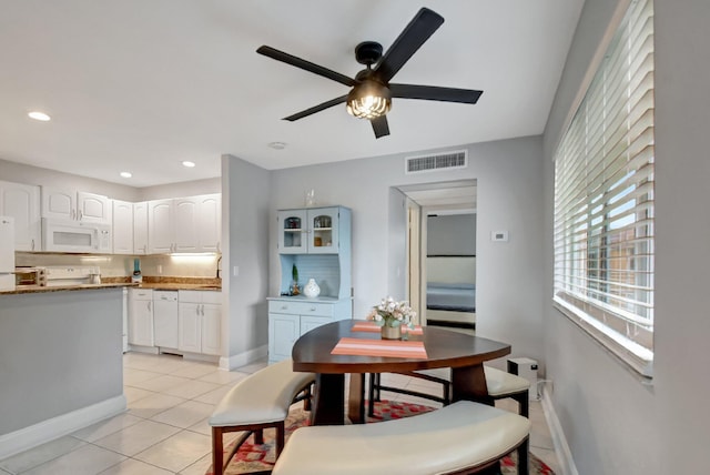 dining room with ceiling fan and light tile patterned floors