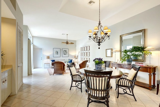 dining area featuring light tile patterned floors and ceiling fan with notable chandelier