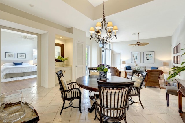 dining room featuring light tile patterned floors and ceiling fan with notable chandelier