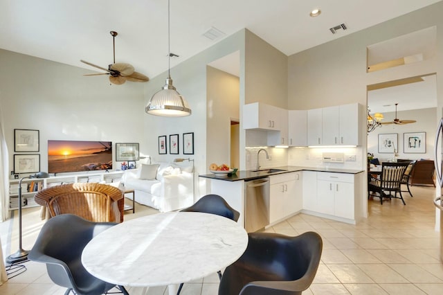 kitchen featuring white cabinetry, dishwasher, ceiling fan, tasteful backsplash, and high vaulted ceiling