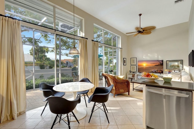 dining space with ceiling fan and light tile patterned floors