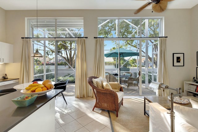 interior space with light tile patterned flooring, a wealth of natural light, and ceiling fan