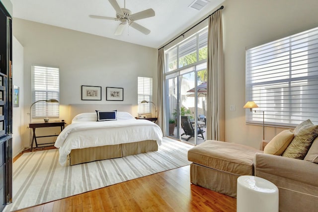 bedroom with access to exterior, ceiling fan, and hardwood / wood-style floors