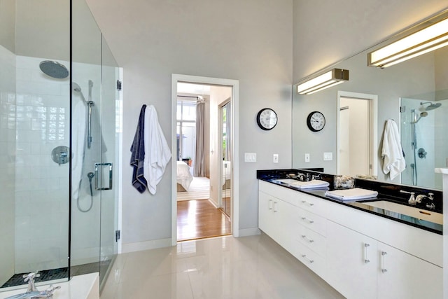 bathroom with tile patterned flooring, vanity, and an enclosed shower