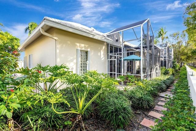 view of side of property with a lanai