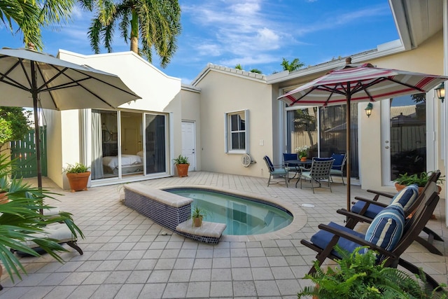 back of house featuring a patio and a hot tub